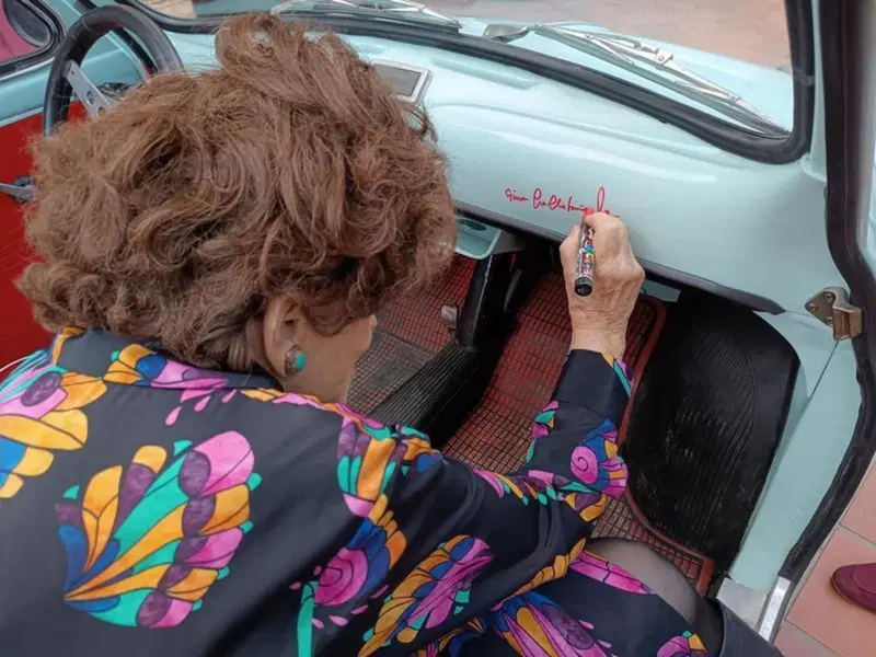 Gina Lollobrigida autografa una Fiat 500 d'epoca